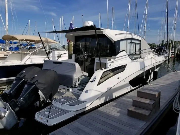 Three Beaches Yacht Photos Pics 2020 Four Winns Vista 355 Coupe OB docked at marina, featuring sleek design and twin outboard engines.