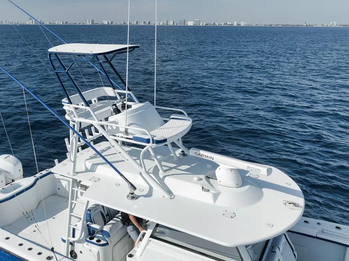  Yacht Photos Pics 2020 Yellowfin 42 Offshore boat with elevated helm, cruising on open water.