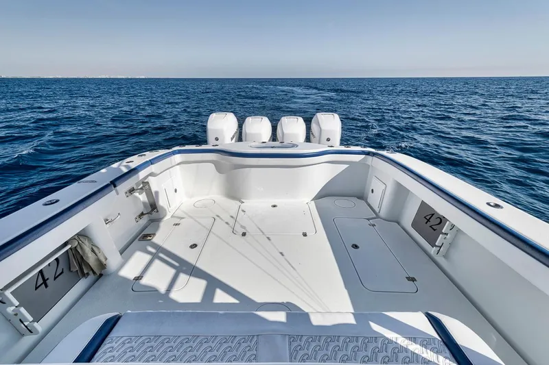  Yacht Photos Pics 2020 Yellowfin 42 Offshore boat on open sea, featuring spacious deck and quad engines.