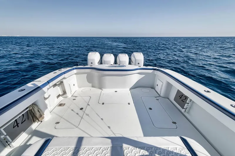  Yacht Photos Pics 2020 Yellowfin 42 Offshore boat on open sea, showcasing spacious deck and triple engines.