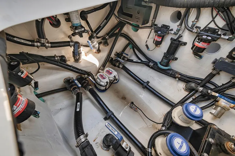  Yacht Photos Pics Engine compartment of a 2020 Yellowfin 42 Offshore boat, showcasing intricate wiring and components.