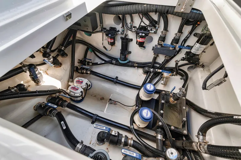  Yacht Photos Pics 2020 Yellowfin 42 Offshore boat engine compartment with complex wiring and plumbing systems.