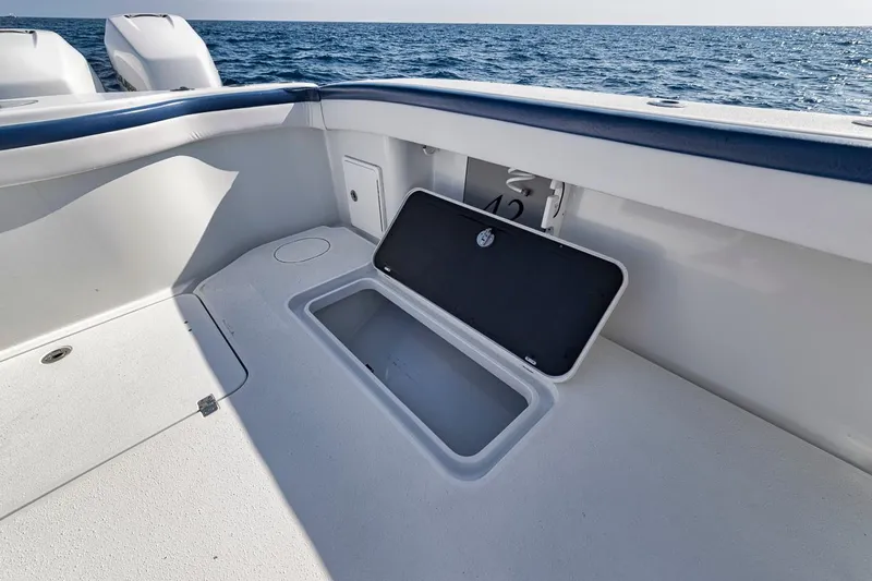  Yacht Photos Pics 2020 Yellowfin 42 Offshore boat deck with open storage compartment, ocean in background.