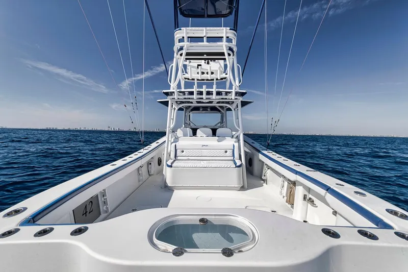  Yacht Photos Pics 2020 Yellowfin 42 Offshore boat on open sea, clear sky, fishing setup.