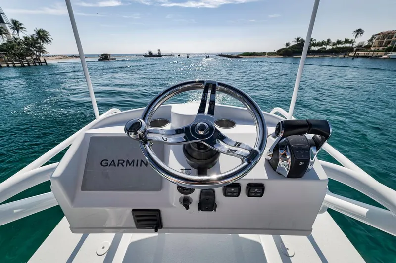  Yacht Photos Pics 2020 Yellowfin 42 Offshore boat helm with Garmin navigation, overlooking serene ocean view.