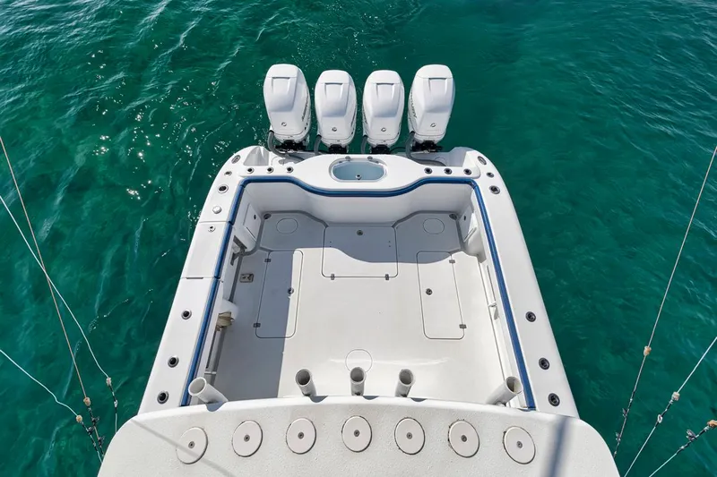  Yacht Photos Pics 2020 Yellowfin 42 Offshore boat with four engines on turquoise water.