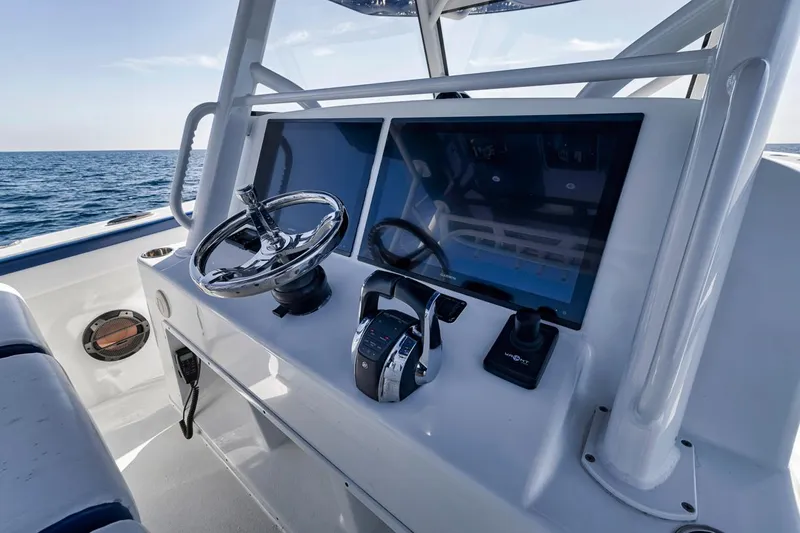  Yacht Photos Pics 2020 Yellowfin 42 Offshore boat helm with dual screens and steering wheel.