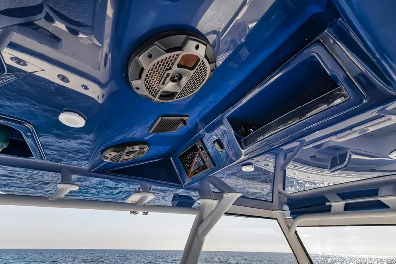  Yacht Photos Pics 2020 Yellowfin 42 Offshore boat interior with blue ceiling and speakers.