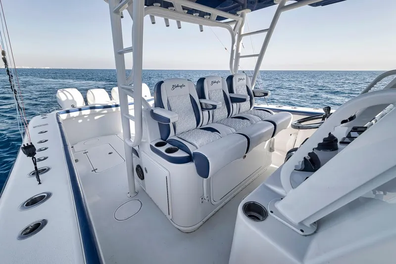  Yacht Photos Pics 2020 Yellowfin 42 Offshore boat interior with cushioned seating, ocean view, and fishing rod holders.