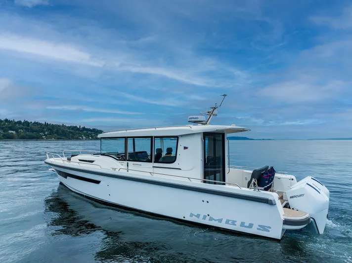 #41 Trade In Yacht Photos Pics 2022 Nimbus C11 boat on calm water under a clear blue sky.