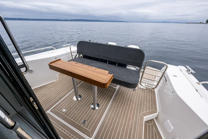 #41 Trade In Yacht Photos Pics Nimbus C11 2022 boat deck with seating and wooden table on calm water.