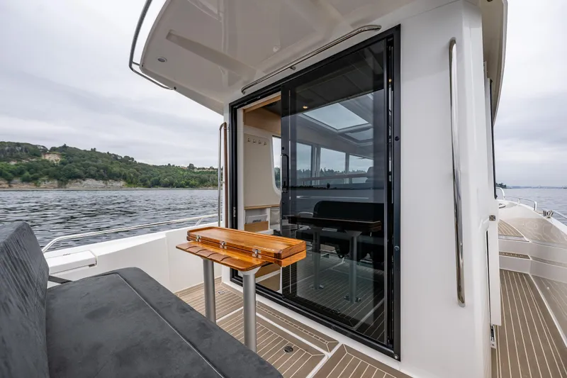 #41 Trade In Yacht Photos Pics Nimbus C11 2022 boat with sleek interior, glass doors, and scenic water view.