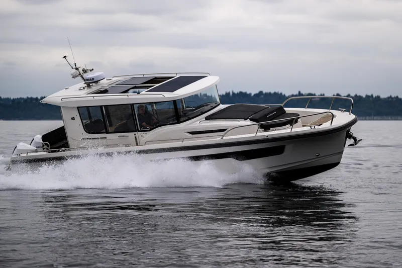 #41 Trade In Yacht Photos Pics 2022 Nimbus C11 boat cruising on water, showcasing sleek design and modern features.