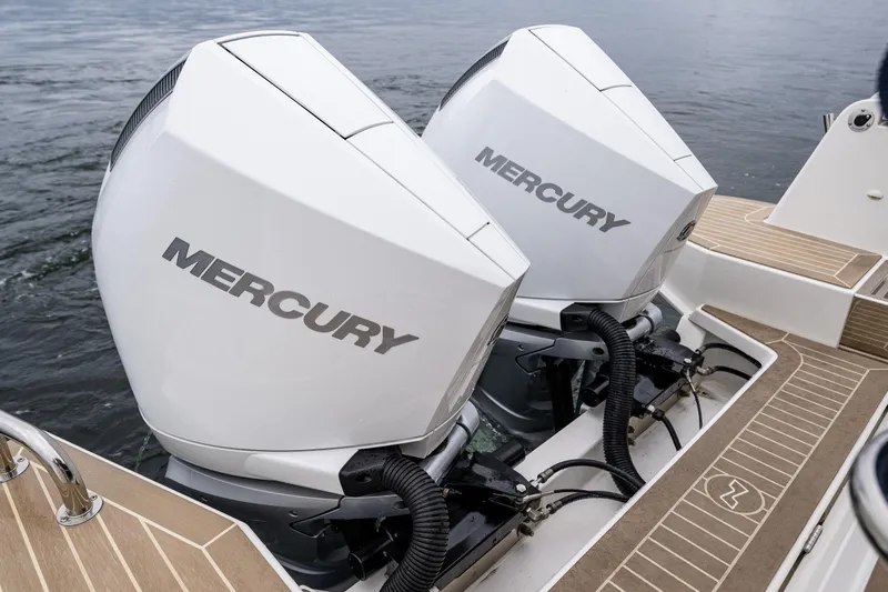 #41 Trade In Yacht Photos Pics Twin Mercury outboard engines on a 2022 Nimbus C11 boat, docked on water.