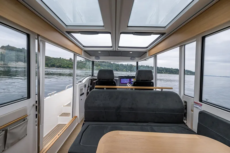 #41 Trade In Yacht Photos Pics Interior of 2022 Nimbus C11 boat with panoramic windows and modern seating.
