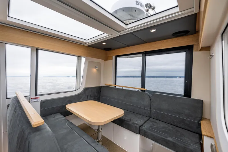 #41 Trade In Yacht Photos Pics Interior of 2022 Nimbus C11 boat with spacious seating and ocean view.