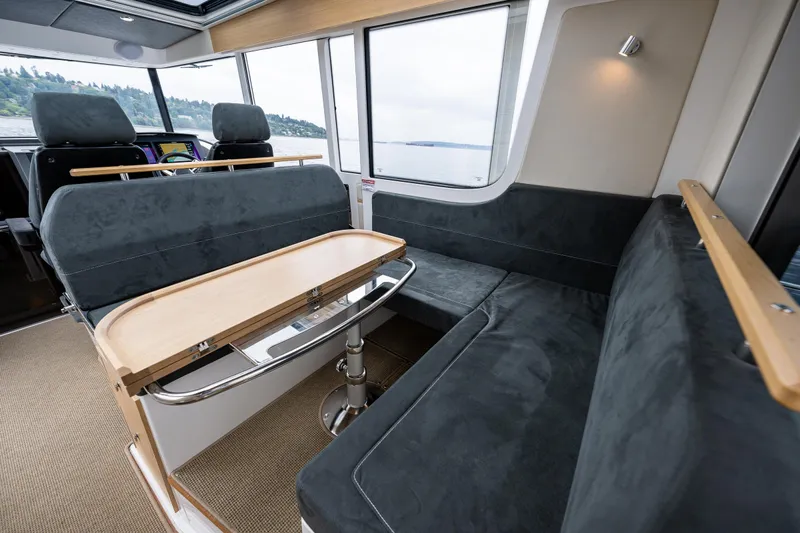 #41 Trade In Yacht Photos Pics Interior of 2022 Nimbus C11 boat with modern seating and table.