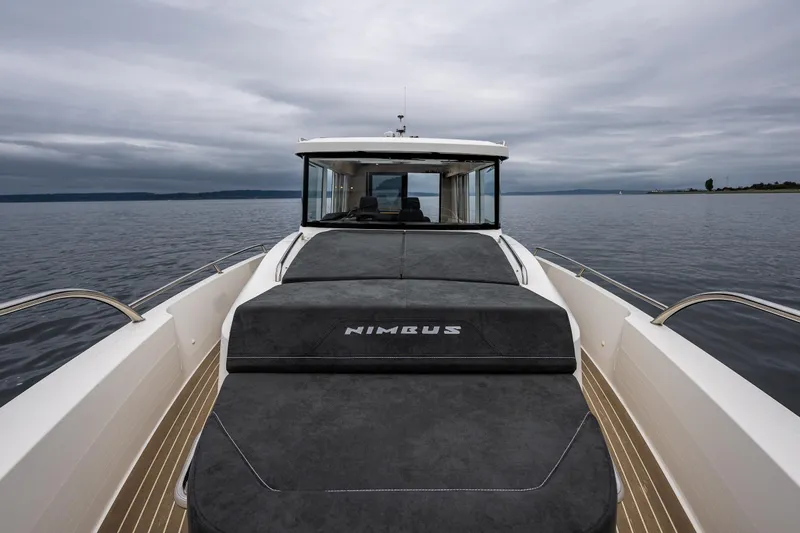 #41 Trade In Yacht Photos Pics 2022 Nimbus C11 boat on calm water under cloudy sky.