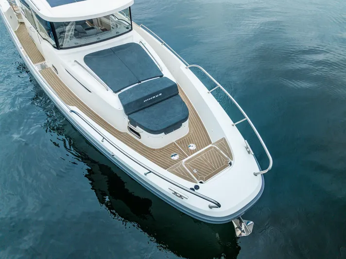 #41 Trade In Yacht Photos Pics 2022 Nimbus C11 boat on calm water, showcasing sleek design and spacious deck.