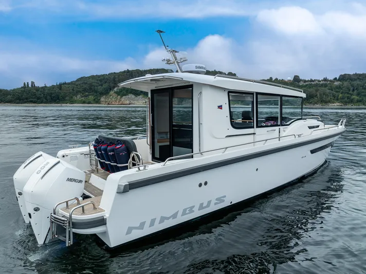 #41 Trade In Yacht Photos Pics 2022 Nimbus C11 boat on water, featuring sleek design and powerful Mercury engines.