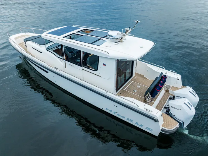 #41 Trade In Yacht Photos Pics Nimbus C11 2022 boat on calm water, featuring sleek design and twin outboard engines.