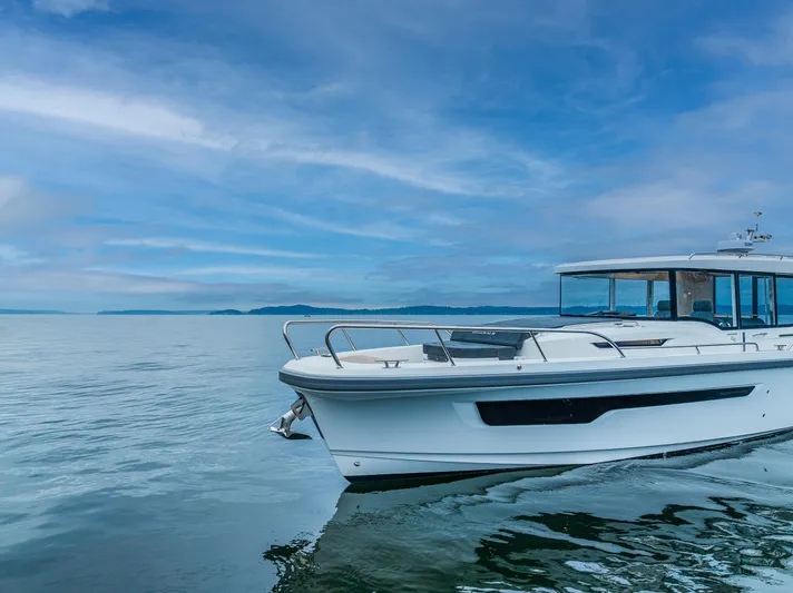 #41 Trade In Yacht Photos Pics Nimbus C11 2022 boat cruising on a calm sea under a blue sky.