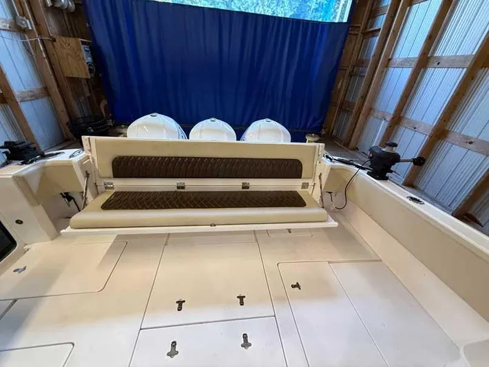  Yacht Photos Pics 2018 Intrepid 410 Evolution boat interior with cushioned seating in a storage area.