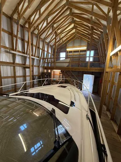  Yacht Photos Pics 2018 Intrepid 410 Evolution boat stored in a wooden boathouse interior.