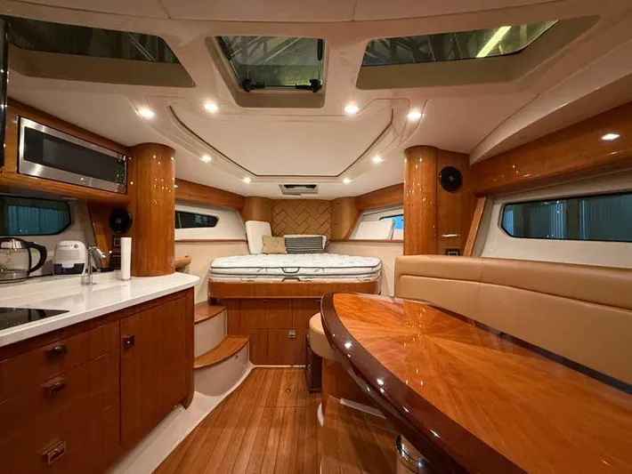 Yacht Photos Pics Luxurious interior of 2018 Intrepid 410 Evolution yacht with wood finishes and modern amenities.