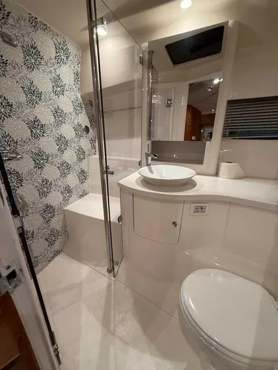  Yacht Photos Pics Luxurious bathroom in 2018 Intrepid 410 Evolution yacht with modern fixtures and floral tile design.