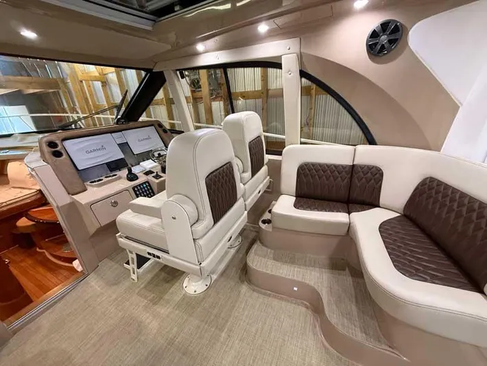  Yacht Photos Pics Luxurious interior of 2018 Intrepid 410 Evolution yacht with plush seating and modern helm.