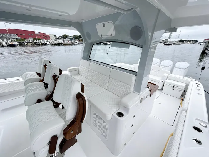  Yacht Photos Pics Luxurious 2025 HCB 48 Campeon boat interior with white seating and waterfront view.