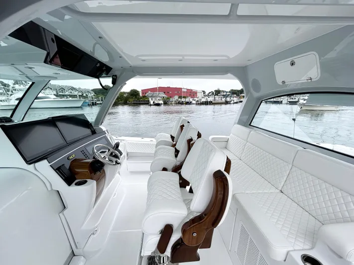  Yacht Photos Pics Luxurious interior of 2025 HCB 48 Campeon boat with white seating and modern dashboard.