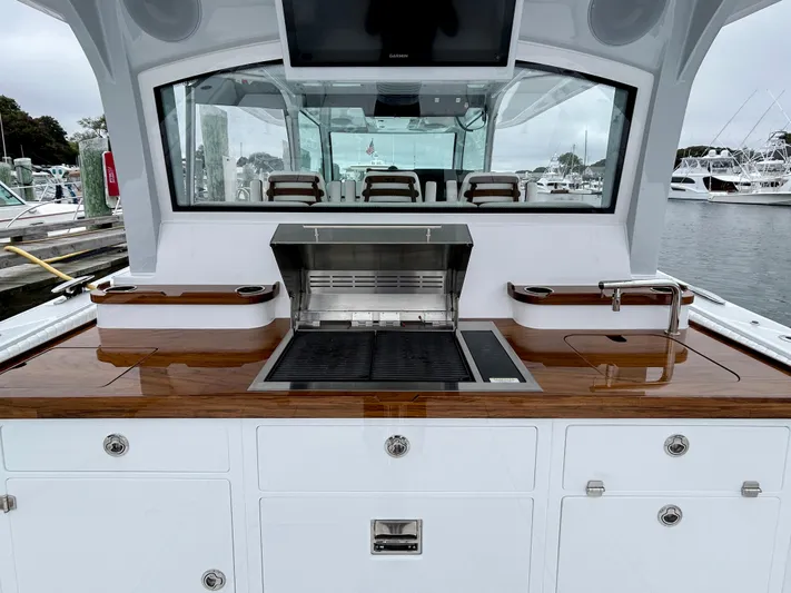  Yacht Photos Pics Outdoor kitchen on 2025 HCB 48 Campeon yacht with grill and sink.