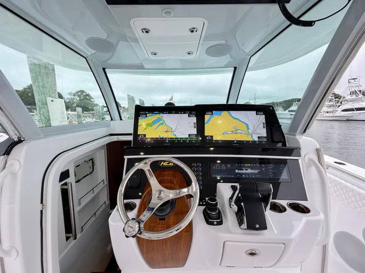  Yacht Photos Pics 2025 HCB 48 Campeon boat helm with dual navigation screens and modern controls.