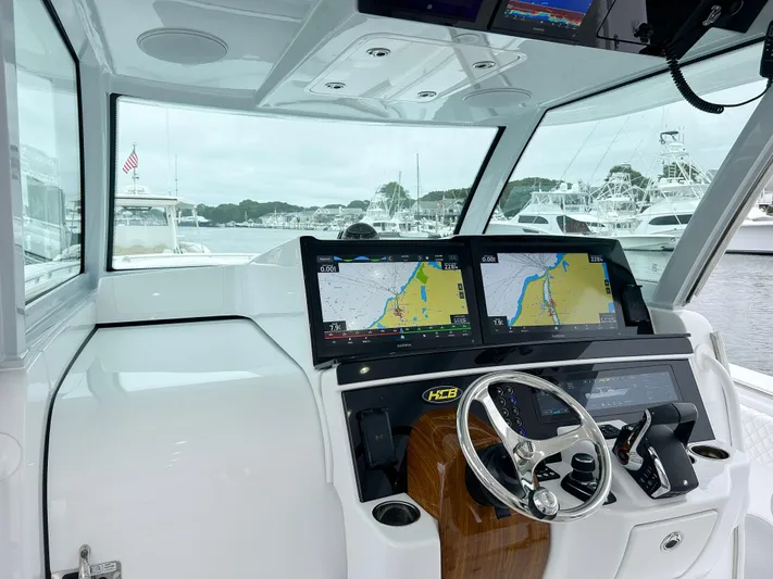  Yacht Photos Pics Interior of 2025 HCB 48 Campeon boat with dual navigation screens and steering wheel.