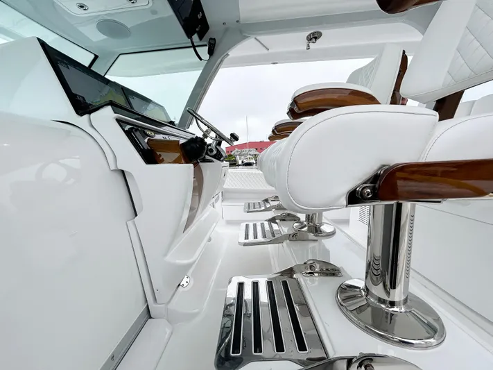  Yacht Photos Pics Luxurious interior of 2025 HCB 48 Campeon boat with sleek white seating.