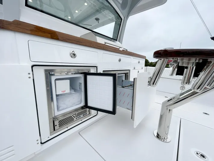  Yacht Photos Pics 2025 HCB 48 Campeon boat interior with open fridge and storage compartments.
