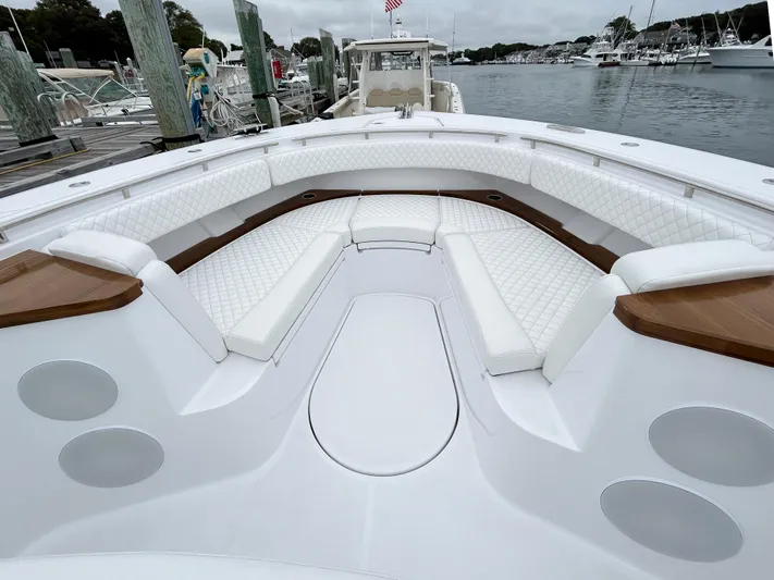  Yacht Photos Pics 2025 HCB 48 Campeon boat with luxurious white seating in a marina.