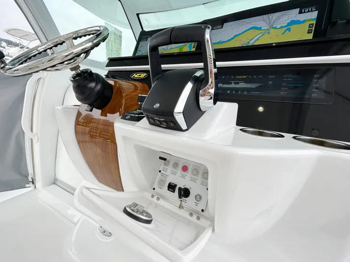  Yacht Photos Pics 2025 HCB 48 Campeon boat dashboard with steering wheel and navigation controls.