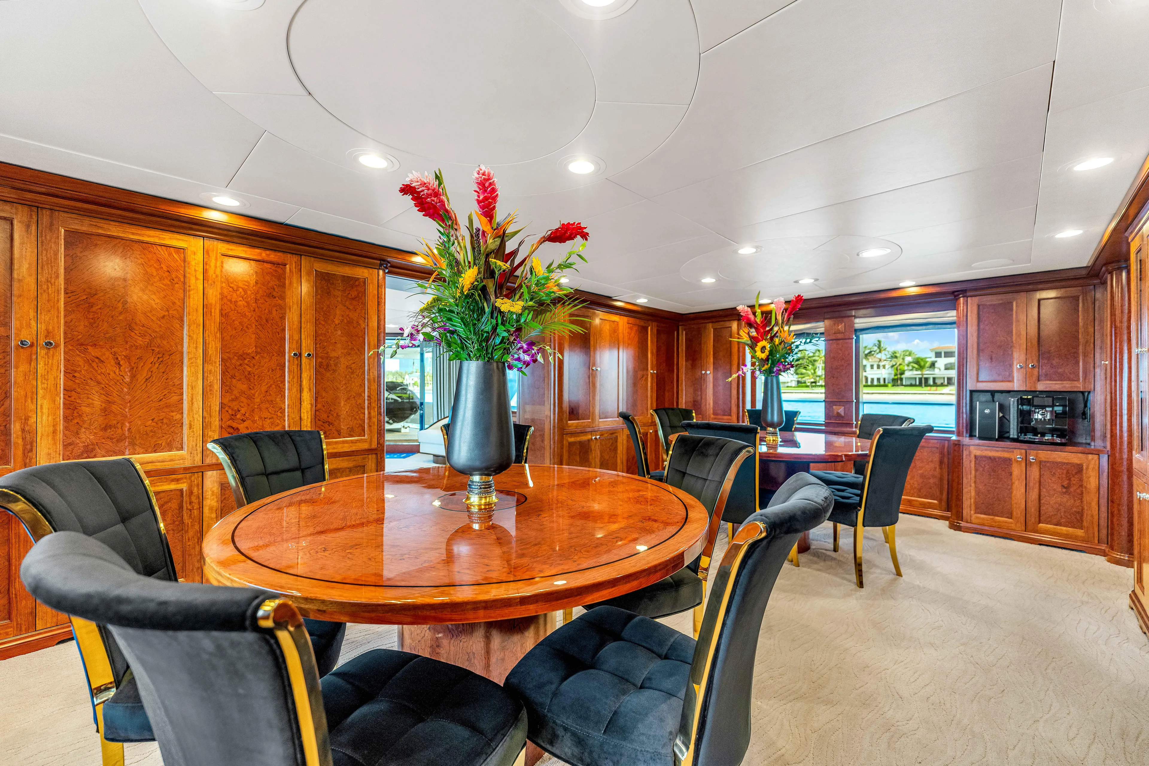 Star Diamond Yacht Photos Pics Luxurious dining area on 1998 Admiral Pilothouse yacht with elegant wood paneling and floral centerpiece.
