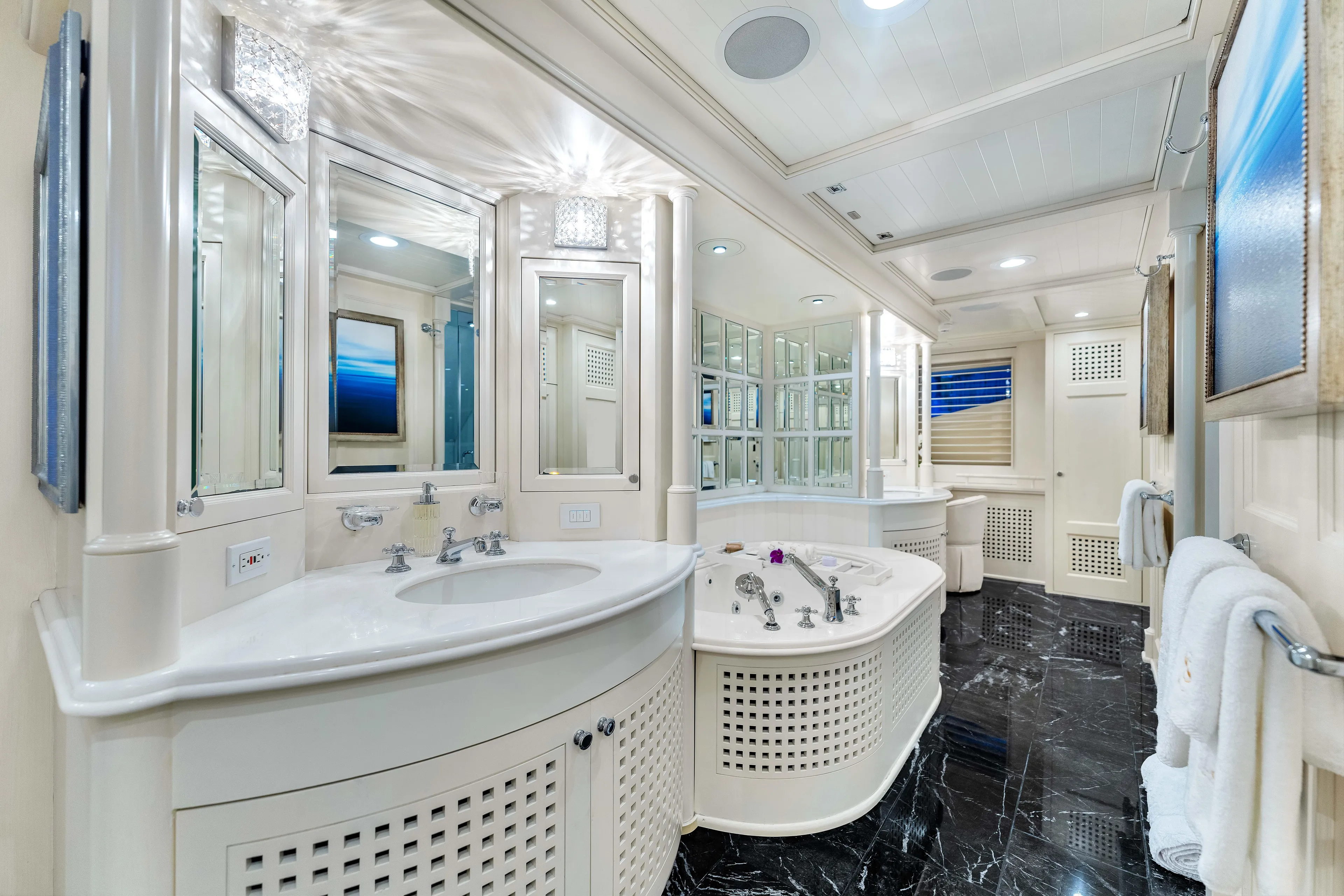Star Diamond Yacht Photos Pics Luxurious yacht bathroom with elegant fixtures, marble flooring, and mirrored cabinets in a 1998 Admiral Pilothouse.