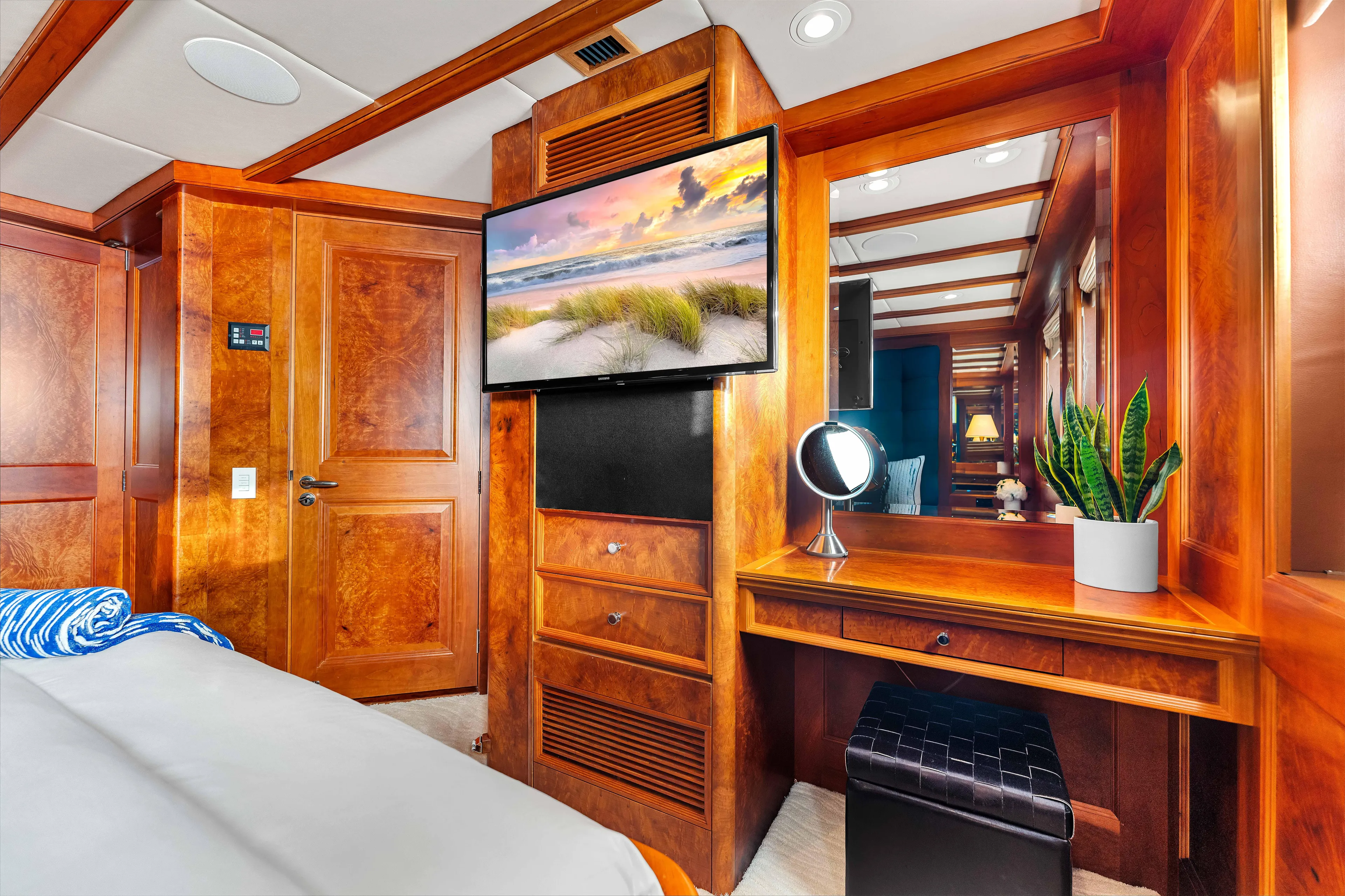 Star Diamond Yacht Photos Pics Luxurious 1998 Admiral Pilothouse interior with wood paneling, TV, vanity, and plant.