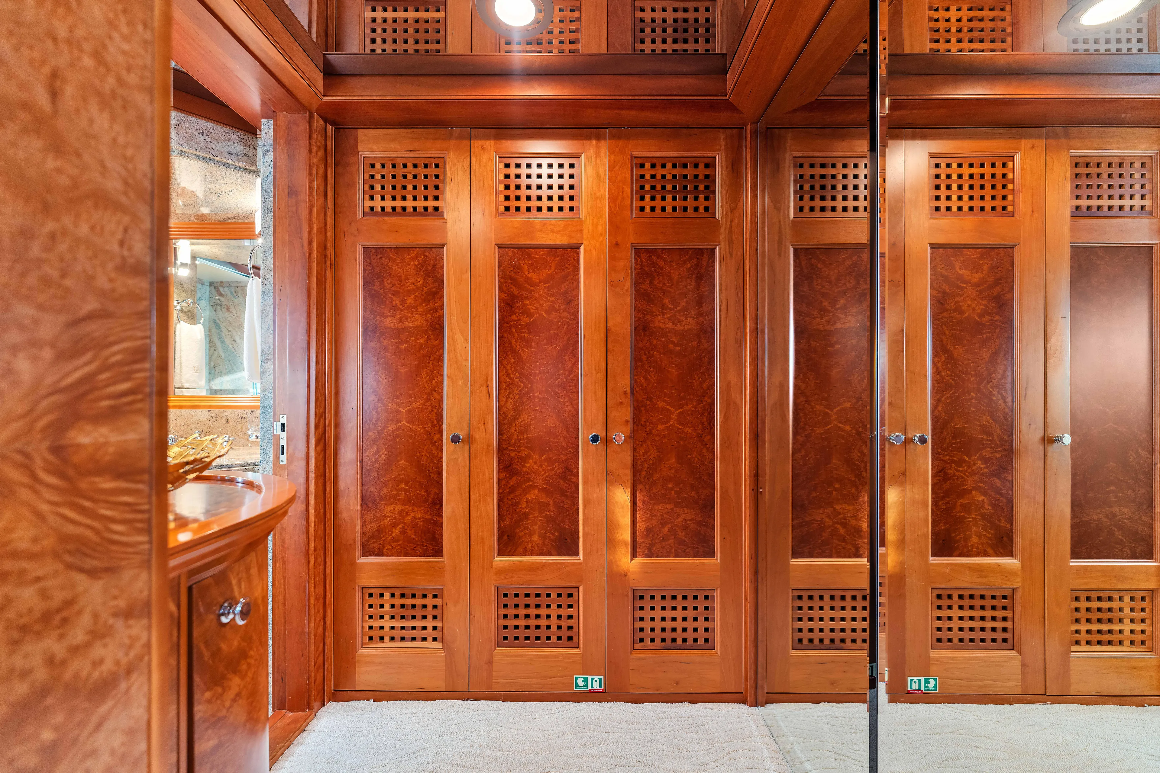 Star Diamond Yacht Photos Pics Luxurious wooden interior of 1998 Admiral Pilothouse yacht with elegant cabinetry and mirrored accents.