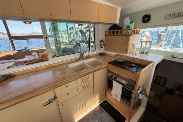 Apres Sea Yacht Photos Pics Modern kitchen interior of 2008 Lagoon 420 yacht with wooden cabinetry and ocean view.