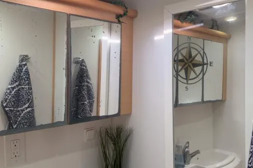 Apres Sea Yacht Photos Pics Bathroom interior of 2008 Lagoon 420 yacht with mirrors and nautical decor.