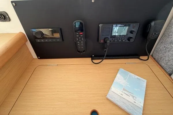 Apres Sea Yacht Photos Pics Control panel of a 2008 Lagoon 420 yacht with communication devices and a manual.
