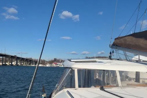 Apres Sea Yacht Photos Pics 2008 Lagoon 420 sailboat on water near a bridge under a clear blue sky.