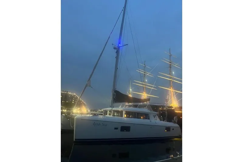 Apres Sea Yacht Photos Pics 2008 Lagoon 420 catamaran docked at night with illuminated masts in the background.