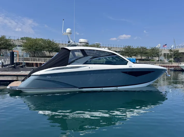  Yacht Photos Pics 2018 Cobalt A36 boat docked on calm water under clear blue sky.